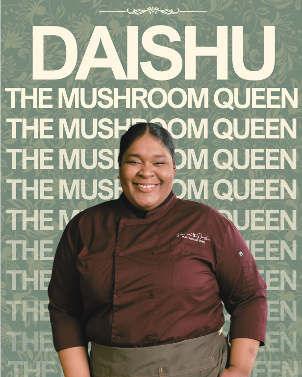 Daishu The Mushroom Queen, smiling in a burgundy chef uniform with her written above the pocket.
